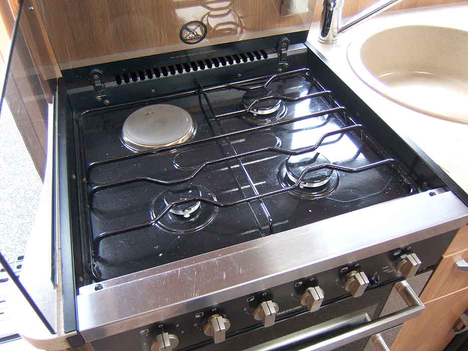 The hob unit with 3 gas burners plus an electric hotplate.